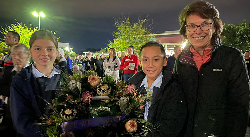 Trinity Primary School Kemps Creek students holding Anzac Day wreath