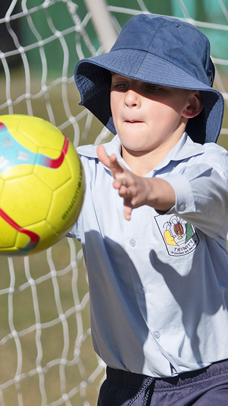 Trinity Catholic Primary school student catching ball